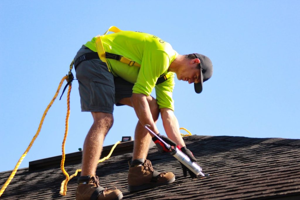 Mastering the First Impression: Your intriguing post title goes here a-man-in-a-yellow-shirt-is-working-on-a-roof-efokg4zmibs